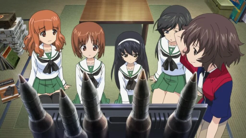 A Girls und Panzer screenshot. The girls are staring silently at upright tank ammo.