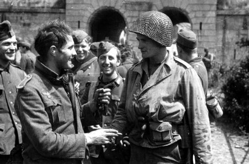 An Axis soldier and a U.S. GI greeting each other either late in or shortly after WWII.