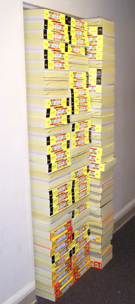 Wikipedia image of a prank with stacks of phonebooks completely blocking a door.
