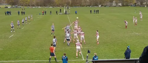 A rugby lineout with a clearly squint throw in. Heriots in blue and white stripee, Watsonians in maroonnand white